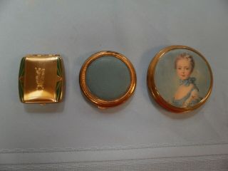 3 Vintage Gold Tone Compacts: Painted Lady On Satin; Enamel; Blue Faux Leather
