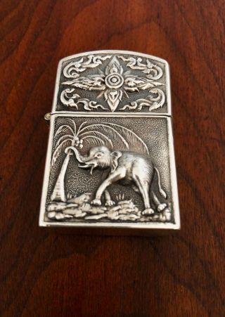 - Siamese Sterling Silver Cased Cigarette Lighter With Elephant & Fighting Gods