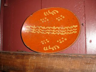 An Extremely Rare Form,  Yellow Slip Decorated Redware Oval Plate,  Coggled Edge