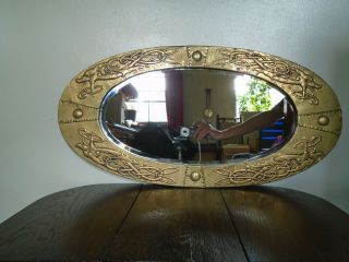 A Brass Arts And Crafts Celtic Design Oval Mirror With Dragons.