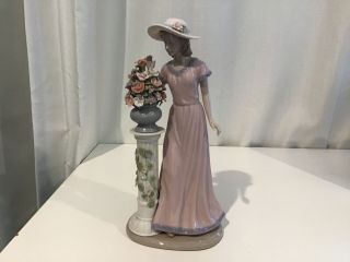 Vintage.  Cosmos Porcelain Figure Of Lady In Pink Dress Looking At Flowers.  454
