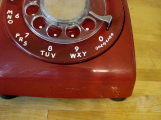Vintage Red AT&T Rotary telephone,  it has a very small crack right front foot 2
