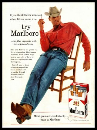1960 Marlboro Cowboy Smoking A Cigarette Sitting Comfortably In A Chair Print Ad