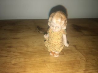 Vintage Bisque Frozen Doll With Jointed Arms & Wearing Simple Dress