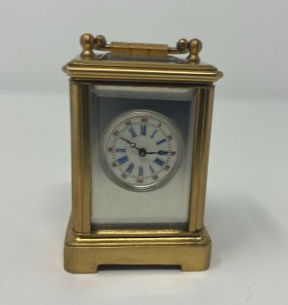 A Miniature Brass Carriage Clock With 4 Bevelled Glass Panels