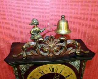Old Wall Clock Chime Clock Regulator With A Man Who Strikes On The Bell On Top