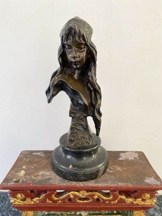 An Art Nouveau Bronze Head And Shoulders Bust Of A Girl On Marble Socle