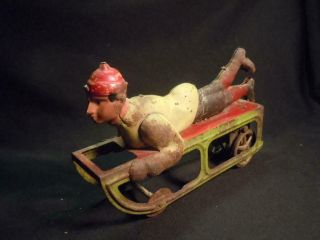 We] Antique Dayton Friction Toy - Boy On Sled