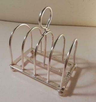 An Antique Arts & Crafts Style Four Division Silver Toast Rack : London 1902
