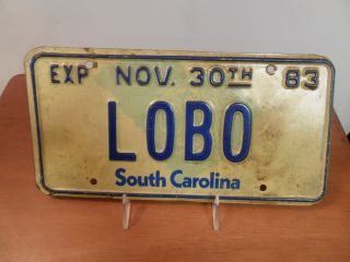 1980 - 1983 South Carolina Vanity License Plate,  Lobo,  State Seal Background