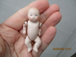 A Tiny Vintage Bisque Porcelain Baby Doll - Jointed Arms & Legs.