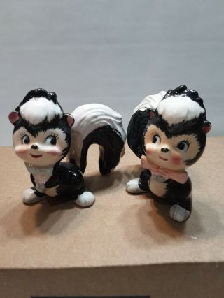 Vintage Japan Boy And Girl Skunk Salt & Pepper Shakers With Blue And Pink Bow.