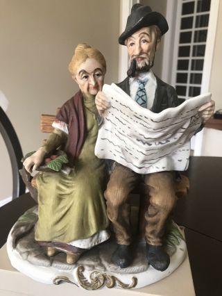 Vintage Elderly Couple Sitting On A Bench Reading Newspaper Porcelain Figurine