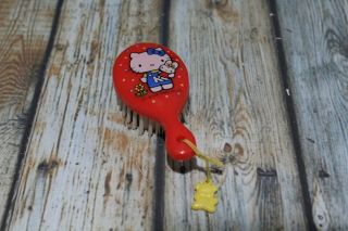 Vintage 1976 Sanrio Hello Kitty Red Brush With Duck Charm.