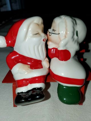 Vintage Santa And Mrs.  Claus Kissing On A Bench Salt And Pepper Shakers.