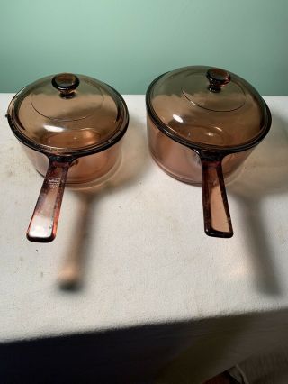 2 Vintage Corning Pyrex Vision Ware 1.  5,  1 L Amber Glass Pot Sauce Pan W/ Lids