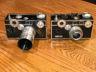 Two Vintage Argus C - 3 35mm Cameras,  A Telephoto Lens And Cases
