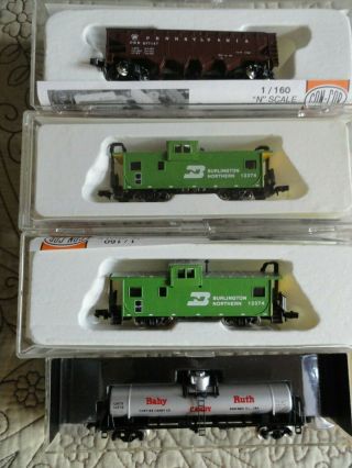4 - Con - Cor N Scale Freight Train Cars - (2) Cabooses; (1) 4 - Bay Hopper; (1) Tanker