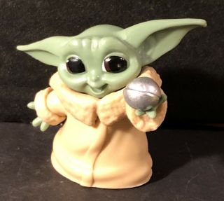 Baby Yoda Holding His Toy Figurine Star Wars Grogu Mandalorian