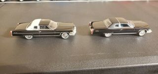 Autoworld Cadillac Coupe Deville Pair
