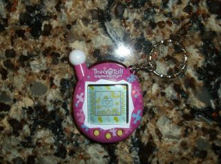 Tamagotchi Connection V4 Pink With Multicolored Flowers Splotches Yellow Button