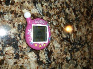 Tamagotchi Connection V4 Pink with Multicolored Flowers Splotches Yellow button 2