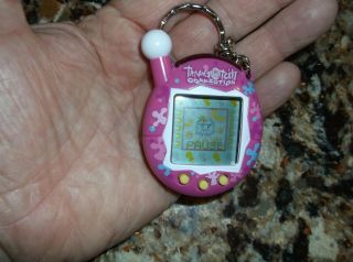 Tamagotchi Connection V4 Pink with Multicolored Flowers Splotches Yellow button 3