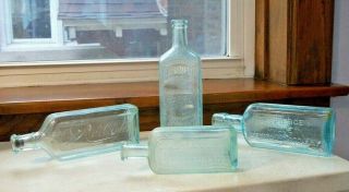 Four Antique Medicine Bottles Dr.  Pierce,  Dr.  Jayne,  Rauleigh,  Hood Sarsaparilla