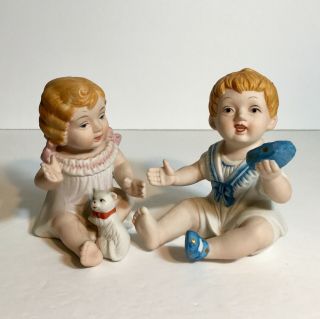 Vintage Royal Crown Bisque Piano Babies Set Of 2 Holding Shoe And Kitten