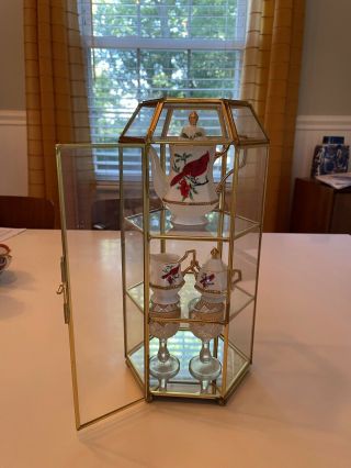 Small glass display case with glass shelves and mirror on bottom shelf. 3