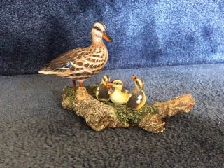 Mother Duck With 3 Ducklings On A Log