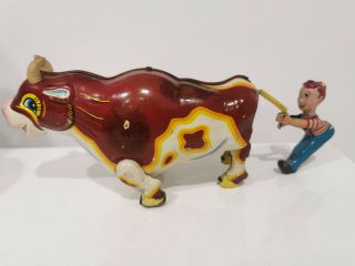 Mikuni Japan Vintage Wind Up Tin Toy.  Cow Pulling Boy.
