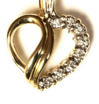 14k yellow gold.  08ct SI1 H round diamond heart pendant 2.  1g estate vintage 3