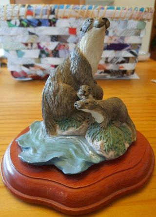 Otter Family Figurine On Wood Base.