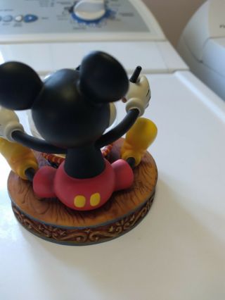 mickey mouse holding snow globe with paint brush and book 3