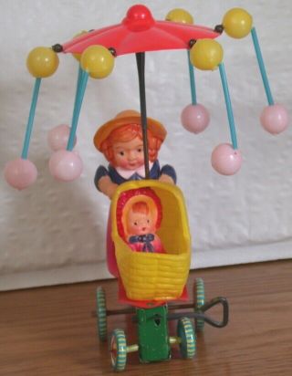 Vintage Celluloid & Tin Girl W Baby Carriage Wind Up Toy Spinning Umbrella Japan
