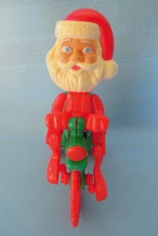 Plastic Red/green Wind Up Toy Santa On A Bike Or Tricycle Candy Holder Vintage