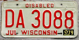 Red On White Wisconsin Disabled License Plate With A 1979 Sticker