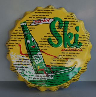 Ski Soda Embossed Yellow Bottle Cap Sign With Surfer