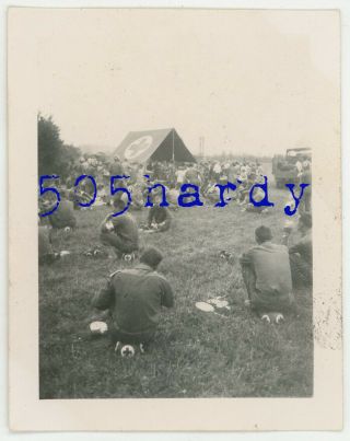 Wwii Us Gi Photo - Medics Sitting On Painted Helmets Eating W/ Locals France