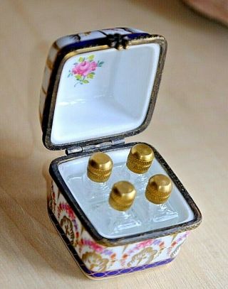 A Hand Painted Porcelain Trinket Box With 4 Miniature Perfume Scent Bottles