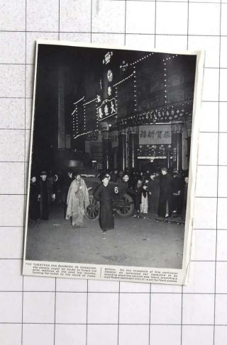 1938 An Armoured Car Standing Outside A Busy Theatre In Shanghai