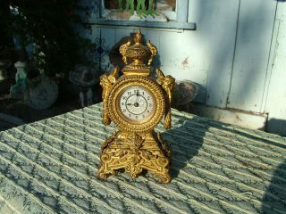 Antique Ornate Gilt Bronze? French? Desk Clock Figural Face Handles Urn Top