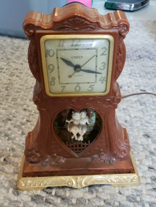 Vintage United " Swinging Sweethearts " Brown Catalin Motion Clock