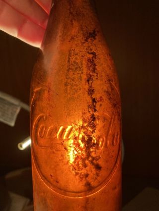 COCA COLA BOTTLING AMBER BOTTLE WITH CURVED ARROW,  JACKSON TENNESSEE DUG 2
