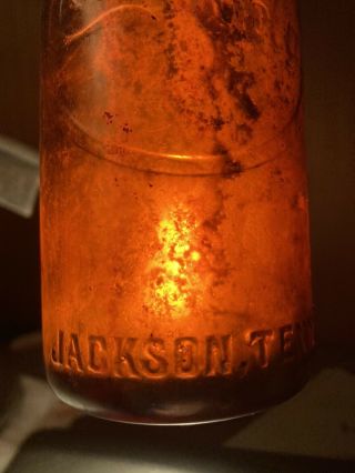 COCA COLA BOTTLING AMBER BOTTLE WITH CURVED ARROW,  JACKSON TENNESSEE DUG 3